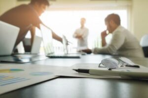 Business team working around a desk in a corporate environment