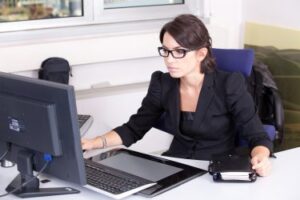 Business office desk with computer and paperwork
